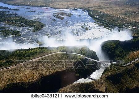 Aerial View, Zambezi river flows into the Victoria Falls, waterfall, border of Zambia and Zimbabwe, Africa View Large Photo Image Stock Image - Aerial View, Zambezi river flows into the Victoria Falls, waterfall, border of Zambia and Zimbabwe, Africa. Fotosearch