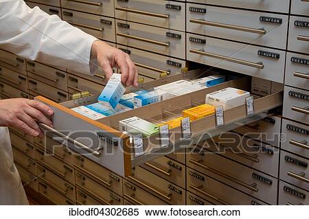 Apotheker taking medication from cabinet in a pharmacy, Germany, Europe View Large Photo Image Stock Photography - Apotheker taking medication from cabinet in a pharmacy, Germany, Europe. Fotosearch