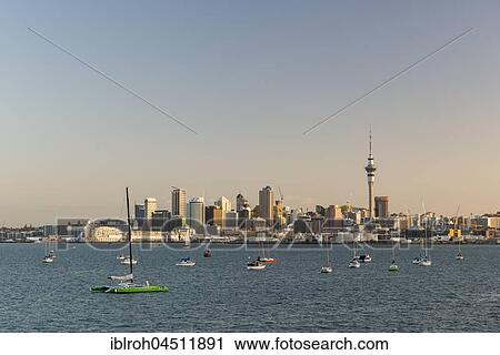 Stock Image - Auckland skyline with Sky Tower, boats anchoring in the sea, North Island, New Zealand, Oceania. Fotosearch