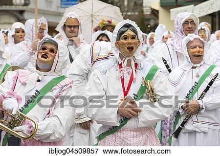 Stock Photo - Aussee Carnival, men with masks and instruments, white robes, Trommelweiber, Bad Aussee, Styria, Austria, Europe. Fotosearch