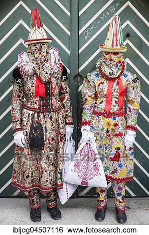 Stock Photograph - Ausseer Flinserl disguised people in costume with ruff, hats, face masking or Gugl, embroidered bags, Bad Aussee, Styria, Austria, Europe. Fotosearch