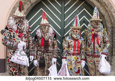 Stock Photography - Ausseer Flinserl, disguised people in costume with ruff, hats, face masking or Gugl, embroidered bags, Bad Aussee, Styria, Austria, Europe. Fotosearch