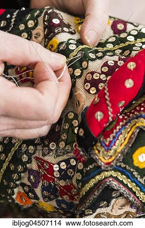 Ausseer Flinserl, hands sewing sequins on costume workshop, different appliqué motives, Bad Aussee, Styria, Austria, Europe View Large Photo Image Picture - Ausseer Flinserl, hands sewing sequins on costume workshop, different appliqué motives, Bad Aussee, Styria, Austria, Europe. Fotosearch