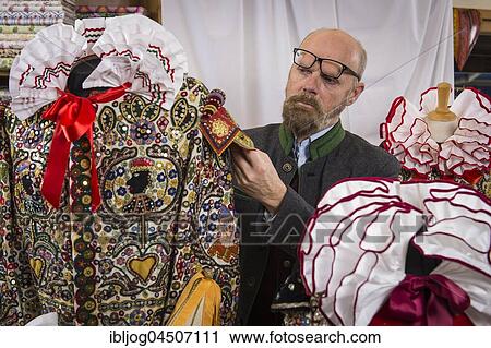 Stock Image - Ausseer Flinserl, man checking costume with ruff in workshop, sequins, different appliqué motives, Bad Aussee, Styria, Austria, Europe. Fotosearch