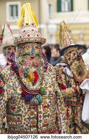 Stock Photograph - Ausseer Flinserl, people in costume with facial masking (Gugl) and hat, Ruff (Kress), sequins, Bad Aussee, Styria, Austria, Europe. Fotosearch