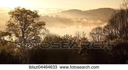 Autumnal forest and lake, Schalkenmehrener Maar at sunrise, Schalkenmehren, Daun, Vulkaneifel, Eifel, Rhineland-Palatinate, Germany, Europe View Large Photo Image Stock Image - Autumnal forest and lake, Schalkenmehrener Maar at sunrise, Schalkenmehren, Daun, Vulkaneifel, Eifel, Rhineland-Palatinate, Germany, Europe. Fotosearch