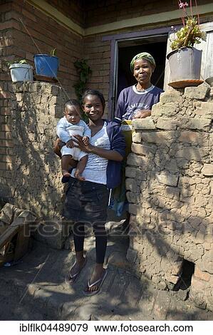 Stock Photo - Baby with mother and grandmother, in front of the House, Fianarantsoa province, Madagascar, Africa. Fotosearch