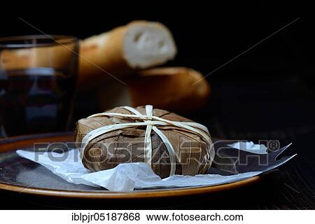 Stock Photo - Banon goat cheese wrapped in chestnut leaves, chestnut leaves. Fotosearch
