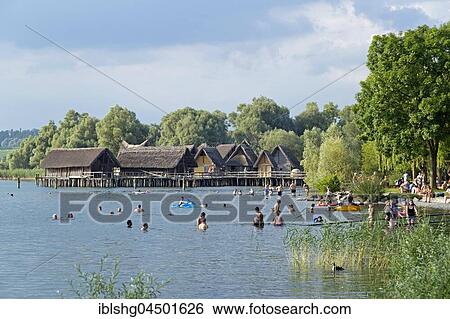 Stock Photograph - Bathers in Lake Constance, stilt houses, Pfahlbaumuseum Unteruhldingen, Baden-Württemberg, Germany, Europe. Fotosearch