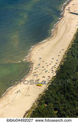 Stock Photo - Bathers, sandy beach on the Baltic Sea, in the seaside resort Niechorze, Baltic Coast, West Pomerania Province, Poland, Europe. Fotosearch