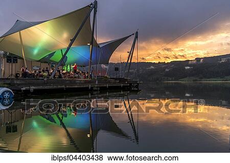 Beach concert at dusk with the band Buhl on the lake stage, Großer Alpsee Lake near Bühl, Allgäu, Bavaria, Germany, Europe View Large Photo Image Stock Photo - Beach concert at dusk with the band Buhl on the lake stage, Großer Alpsee Lake near Bühl, Allgäu, Bavaria, Germany, Europe. Fotosearch