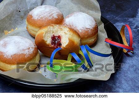 Stock Photography - Berlin pancakes with streamers, bite. Fotosearch