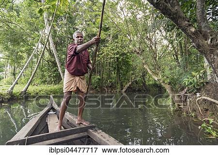 Boatman with punting pole on river, Backwaters, Kerala, India, Asia View Large Photo Image Stock Photo - Boatman with punting pole on river, Backwaters, Kerala, India, Asia. Fotosearch
