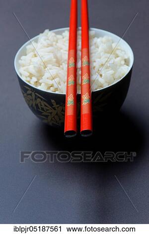 Stock Image - Boiled rice in bowl with chopsticks, basmati rice. Fotosearch