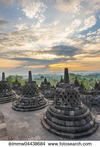 Picture - Borobudur Temple at sunrise, stupas, cloudy sky, Borobudur, Yogyakarta, Java, Indonesia, Asia. Fotosearch