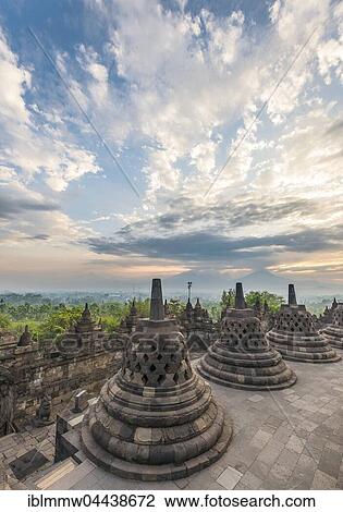 Stock Image - Borobudur Temple at sunrise, stupas, cloudy sky, Borobudur, Yogyakarta, Java, Indonesia, Asia. Fotosearch