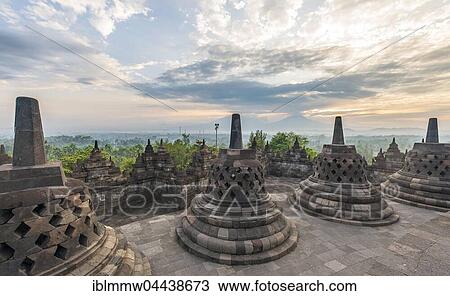 Stock Image - Borobudur Temple at sunrise, stupas, cloudy sky, Borobudur, Yogyakarta, Java, Indonesia, Asia. Fotosearch