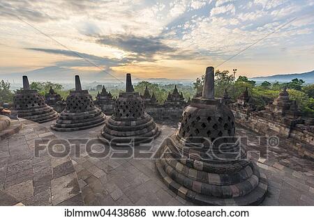 Stock Photograph - Borobudur Temple at sunrise, stupas, cloudy sky, Borobudur, Yogyakarta, Java, Indonesia, Asia. Fotosearch