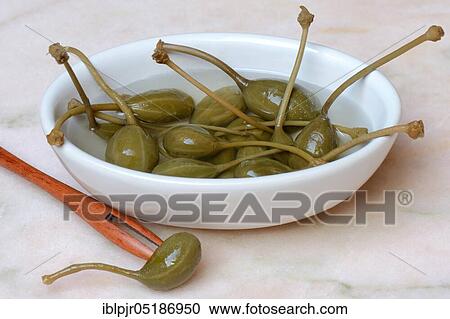 Stock Image - Bowl with caper apples, marinated, caper apple ( Capparis spinosa). Fotosearch