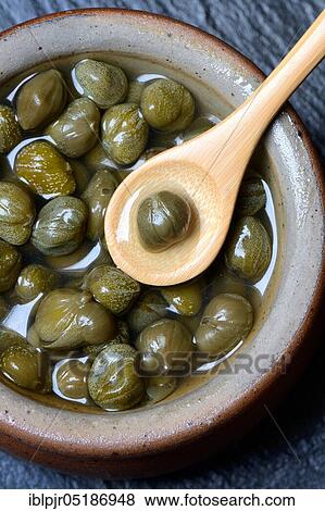 Bowl with capers, pickled ( Capparis spinosa) View Large Photo Image Stock Photo - Bowl with capers, pickled ( Capparis spinosa). Fotosearch
