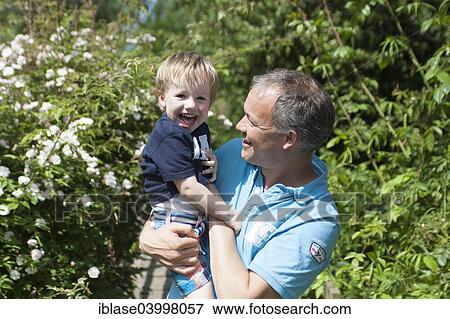 Boy, 2 years, with big smile being held and tickled by his father, Netherlands View Large Photo Image Stock Photo - Boy, 2 years, with big smile being held and tickled by his father, Netherlands. Fotosearch