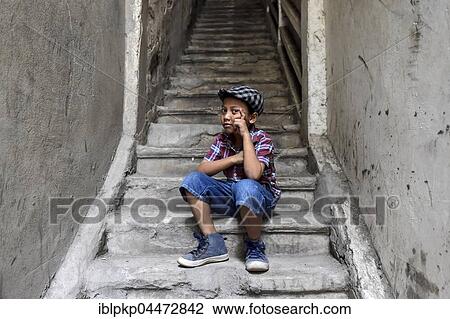 Boy on staircase with shirt and flat cap, Phnom Penh Province, Cambodia, Asia View Large Photo Image Stock Image - Boy on staircase with shirt and flat cap, Phnom Penh Province, Cambodia, Asia. Fotosearch