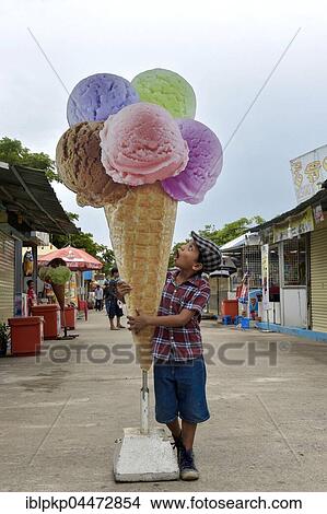 Boy with oversized cardboard ice cream cone, Phnom Penh Province, Cambodia, Asia View Large Photo Image Picture - Boy with oversized cardboard ice cream cone, Phnom Penh Province, Cambodia, Asia. Fotosearch