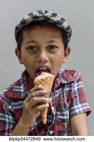 Boy with shirt and flat cap eating ice cream, portrait, Phnom Penh Province, Cambodia, Asia View Large Photo Image Stock Photo - Boy with shirt and flat cap eating ice cream, portrait, Phnom Penh Province, Cambodia, Asia. Fotosearch