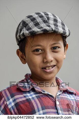 Stock Image - Boy with shirt and flat cap, portrait, Phnom Penh Province, Cambodia, Asia. Fotosearch