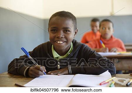 Stock Photograph - Boy writing, 12 years, Primary School, Fianarantsoa, Madagascar, Africa. Fotosearch