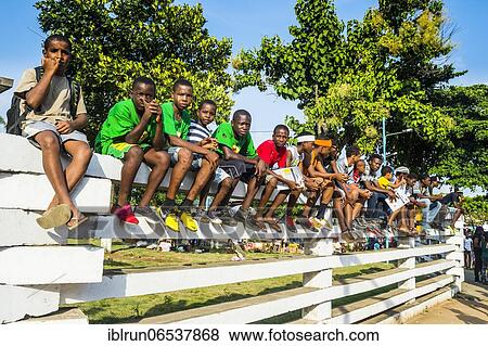 Boys on a wall watching the Carneval parade in the town of Sao Tome, Sao Tome and Principe, Atlantic ocean, Africa View Large Photo Image Stock Photo - Boys on a wall watching the Carneval parade in the town of Sao Tome, Sao Tome and Principe, Atlantic ocean, Africa. Fotosearch