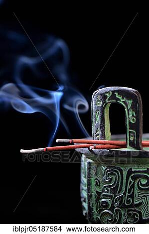 Picture - Burning incense sticks on incense burner, aromatherapy, fragrance. Fotosearch