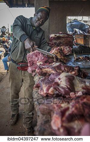 Butcher with meat at market, street scene, Bamenda, North-West Region, Cameroon, Africa View Large Photo Image Stock Photo - Butcher with meat at market, street scene, Bamenda, North-West Region, Cameroon, Africa. Fotosearch