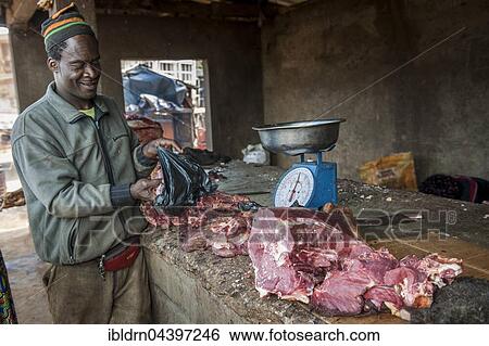 Butcher with meat at market, street scene, Bamenda, North-West Region, Cameroon, Africa View Large Photo Image Stock Photograph - Butcher with meat at market, street scene, Bamenda, North-West Region, Cameroon, Africa. Fotosearch