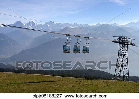 Cabins of the Niederhornbahn, mountain lift, cable car, aerial cable cars, view of Eiger, Mönch and Jungfrau, Emmental Alps, Bernese Oberland, Switzerland, Europe View Large Photo Image Stock Photo - Cabins of the Niederhornbahn, mountain lift, cable car, aerial cable cars, view of Eiger, Mönch and Jungfrau, Emmental Alps, Bernese Oberland, Switzerland, Europe. Fotosearch