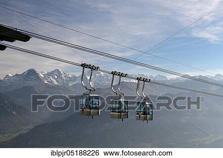 Cabins of the Niederhornbahn, mountain lift, cable car, aerial cable cars, view of Eiger, Mönch and Jungfrau, Emmental Alps, Bernese Oberland, Switzerland, Europe View Large Photo Image Stock Photograph - Cabins of the Niederhornbahn, mountain lift, cable car, aerial cable cars, view of Eiger, Mönch and Jungfrau, Emmental Alps, Bernese Oberland, Switzerland, Europe. Fotosearch