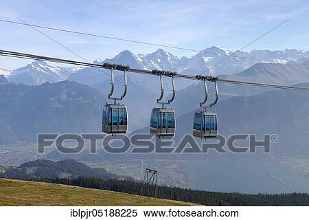 Stock Photography - Cabins of the Niederhornbahn, mountain lift, cable car, aerial cable cars, view of Eiger, Mönch and Jungfrau, Emmental Alps, Bernese Oberland, Switzerland, Europe. Fotosearch