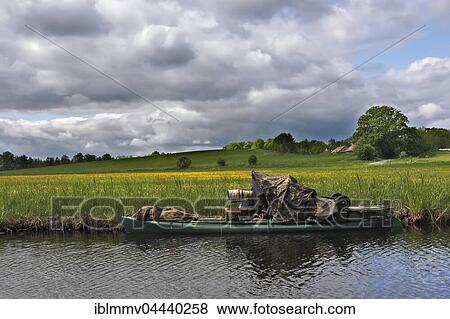 Camouflaged nature photographer on boat, Müritz National Park, Mecklenburg-Western Pomerania, Germany, Europe View Large Photo Image Stock Photo - Camouflaged nature photographer on boat, Müritz National Park, Mecklenburg-Western Pomerania, Germany, Europe. Fotosearch