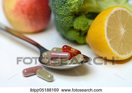 Stock Photo - Capsules on spoon, Omega-3 fatty acids, vitamins, fish oil capsule. Fotosearch