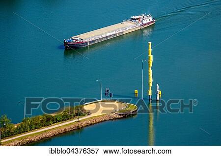 Stock Photo - cargo ship on Emscher River, Emscherkunst 2016, steel sculpture reemrenreh by Bogomir Ecker, Herner sea, Emscher Island, Ruhr district, North Rhine-Westphalia, Germany, Europe. Fotosearch
