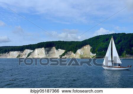 Chalk coast with sailing boat, near Saßnitz, island of Rügen, Jasmund National Park, Mecklenburg-Western Pomerania, Germany, Europe View Large Photo Image Stock Photograph - Chalk coast with sailing boat, near Saßnitz, island of Rügen, Jasmund National Park, Mecklenburg-Western Pomerania, Germany, Europe. Fotosearch