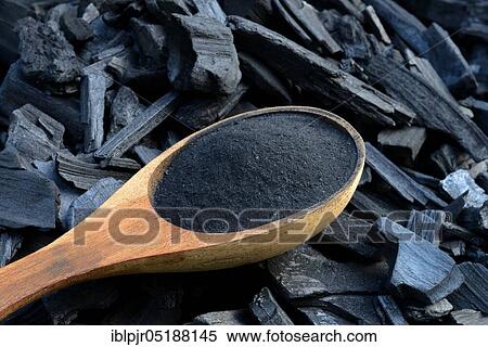 Stock Photography - Charcoal and powdered charcoal in trowel, wood, coal, charcoal, powdered charcoal. Fotosearch