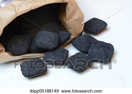Stock Photo - Charcoal briquettes, paper bag. Fotosearch