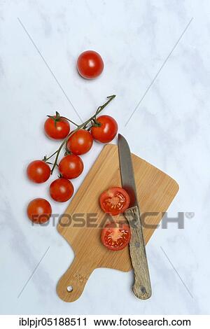 Cherry tomatoes with cutting board and kitchen knife, Solanum lycopersicum, cherry tomato, cherry tomato, cherry tomato View Large Photo Image Stock Image - Cherry tomatoes with cutting board and kitchen knife, Solanum lycopersicum, cherry tomato, cherry tomato, cherry tomato. Fotosearch