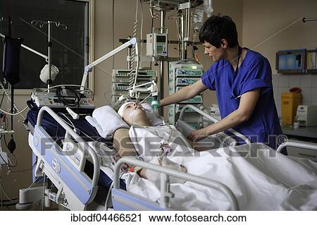Stock Image - Child in hospital bed is attended by intensive care nurse, Intensive Care Unit, Children's Hospital Altona, Hamburg, Germany, Europe. Fotosearch