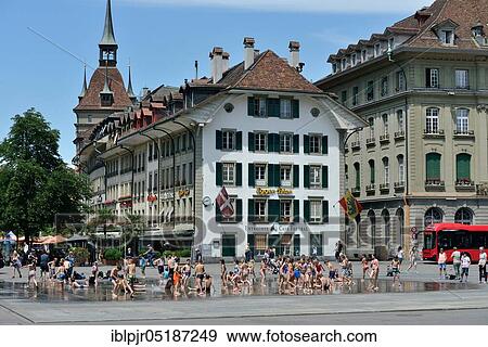 Stock Photo - Children at the Bundesplatz, Canton, Water games, Water feature, Bernese Old Town, Federal Parliament, Old Town, Switzerland, Europe. Fotosearch