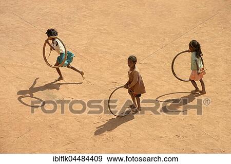 Children playing with tires on village street, Bevato, Tsiroanomandidy district, Bongolava region, Madagascar, Africa View Large Photo Image Stock Photo - Children playing with tires on village street, Bevato, Tsiroanomandidy district, Bongolava region, Madagascar, Africa. Fotosearch