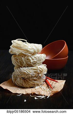 Picture - Chinese noodles and bowls, uncooked, nest noodles, nest noodles. Fotosearch