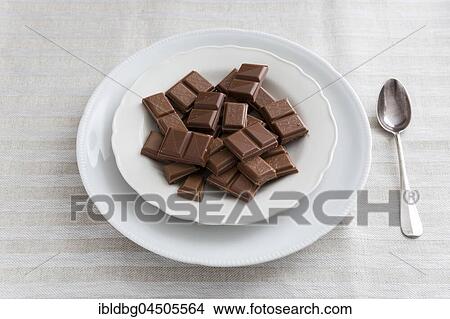 Chocolate on white porcelain plate, silver spoon View Large Photo Image Picture - Chocolate on white porcelain plate, silver spoon. Fotosearch