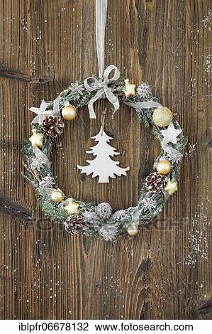 Christmas wreath on brown wooden wall with fir tree View Large Photo Image Stock Image - Christmas wreath on brown wooden wall with fir tree. Fotosearch